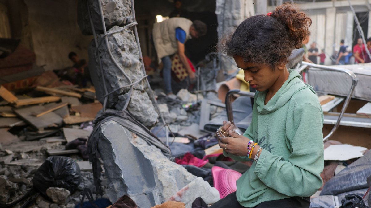 A girl collects belongings as Palestinians check the site of an overnight Israeli strike, in Jabalia, Gaza Strip, Palestine, May 30, 2025. (AFP Photo)