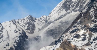 This photograph shows dust rising above the Bietschhorn mountain after the Birch Glacier collapsed, triggering a massive landslide that threw tons of rock, ice, and scree down the mountainside into the valley, destroying the village of Blatten, Wiler, in the Swiss Alps on May 31, 2025. (AFP Photo)