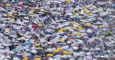 Muslim pilgrims use umbrellas to shield themselves from the sun as they gather outside the Nimrah Mosque to offer the noon prayers in Arafat, on the second day of the annual hajj pilgrimage, near the holy city of Mecca, Saudi Arabia, June 15, 2024. (AP Photo)