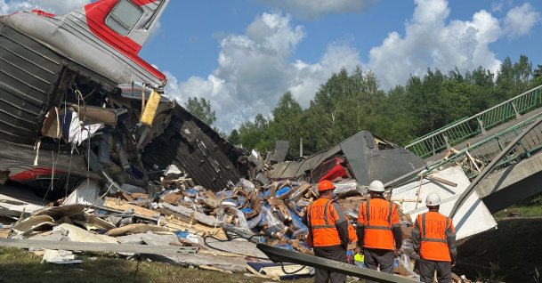Emergency workers at the scene, after a road bridge collapsed onto railway tracks due to an explosion in the Bryansk region, Russia, June 1, 2025. (Reuters Photo)