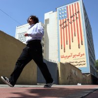 An Iranian man walks past an anti-U.S. mural in Tehran, Iran, May 21, 2025. (EPA Photo)
