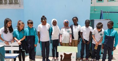 Students pose with a handmade cat house crafted from recycled materials as part of a Zero Waste Project initiative at a Maarif school, Dakar, Senegal, May 16, 2025. (AA Photo)