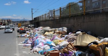 Garbage bags pile up along a sidewalk in the Kordon area as municipal workers continue their strike in Izmir, Türkiye, June 2, 2025. (AA Photo)