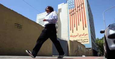An Iranian man walks past an anti-U.S. mural in Tehran, Iran, May 21, 2025. (EPA Photo)