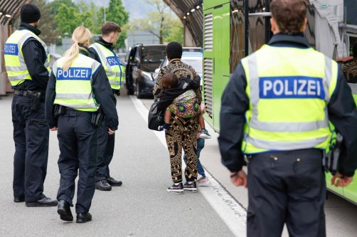 A Nigerian woman and her two children are escorted by German federal police officers after being required to disembark from a tourist bus at the Kiefersfelden border control station in southern Germany, upon entering from Austria, May 9, 2025. (AFP File Photo)