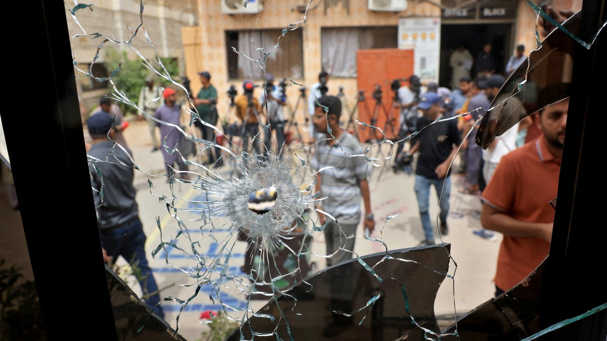 Members of media are seen through a broken glass window inside the premises of the district Malir jail after dozens of prisoners escaped from the jail on the outskirts of Karachi, Pakistan, June 3, 2025. (Reuters Photo)
