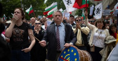 A person beats a drum with the euro logo crossed out in red on the drumhead during a demonstration against Bulgaria entering the eurozone in Sofia, Bulgaria, May 31, 2025. (AFP Photo)