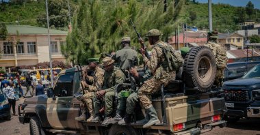 M23 rebel soldiers board pickup trucks to escort the vehicles of coordinator Corneille Nanga and governor Erasto after attending a thanksgiving service organized by the M23/AFC administration, Goma, DRC, May 18, 2025. (AFP Photo)