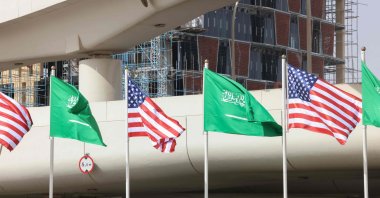 The flags of Saudi Arabia and the U.S. flutter in front of a building under construction on a main road, hours before a visit by U.S. President Donald Trump to the desert kingdom, Riyadh, Saudi Arabia, May 12, 2025.  (AFP Photo)