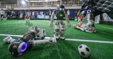 Robot football players compete in a football game during the 2021 RoboCup China Open, also the RoboCup Asia-Pacific (RCAP) Tianjin Invitation Tournament, which is a part of the fifth World Intelligence Congress, at Tianjin Konggang Sports Center, Tianjin, China, May 21, 2021. (Getty Images Photo)
