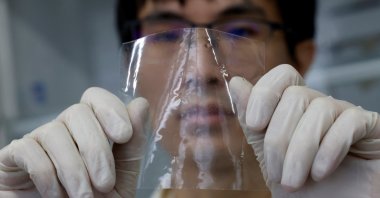 A researcher shows a sample of ocean-degradable plastic at the Center for Emergent Matter Science (CEMS) of the Japanese research institution Riken, Wako, Saitama Prefecture, Japan, May 27, 2025. (Reuters Photo)
