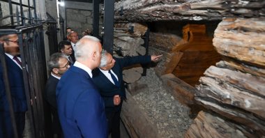 Culture and Tourism Minister Mehmet Nuri Ersoy examines a newly unearthed, untouched wooden tomb chamber believed to belong to the Phrygian royal family at the ancient city of Gordion in Ankara, June 3, 2025. (DHA Photo)