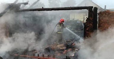 A firefighter works at the site of a Russian drone strike in Pryluky, central Ukraine, June 5, 2025. (IHA Photo)