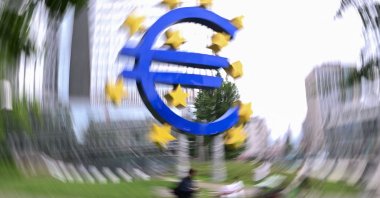 Pedestrians walk past the &quot;Euro Sculpture&quot; by German artist Ottmar Horl in front of the former seat of the European Central Bank (ECB) at the Eurotower, ahead of a press conference on the Eurozone&#039;s monetary policy, in Frankfurt, Germany, June 5, 2025. (AFP Photo)