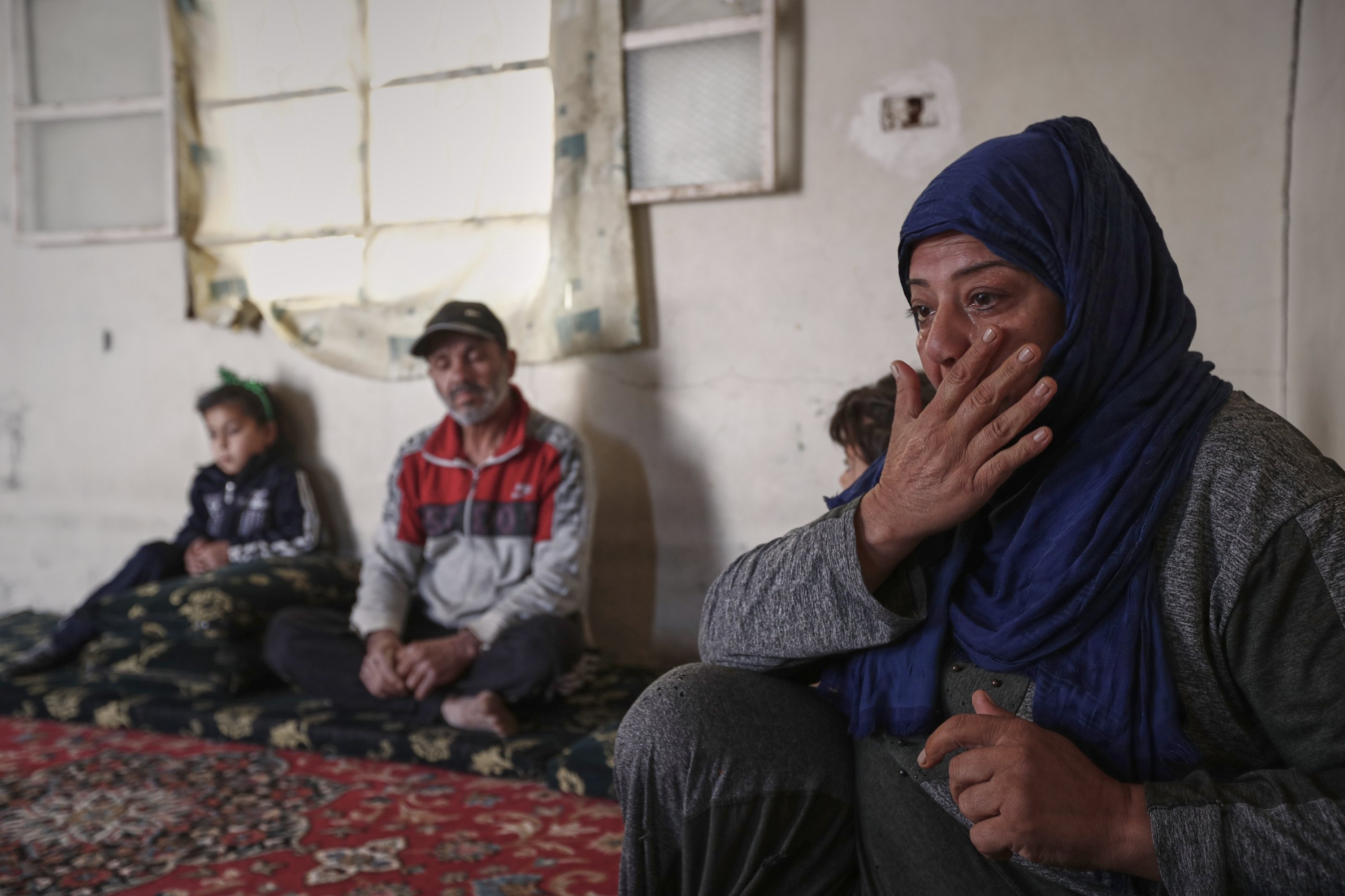 Yasmine al-Saleh reacts as she speaks after she and her family returned to their home following nine years in a notorious displacement camp in the Syrian desert, al-Qaryatayn, Syria, June 3, 2025. (AP Photo)