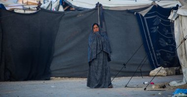 A Palestinian woman stands in front of tents for displaced people on the first day of the Muslim Eid al-Adha festival, Nuseirat, Gaza Strip, Palestine, June 6, 2025. (AFP Photo)