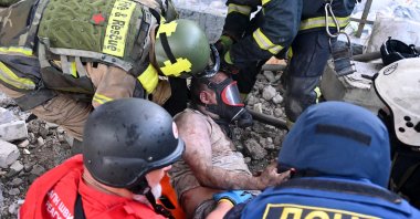 Rescuers carry a wounded person out of the ruins of a civilian plant following Russian powerful attacks on eastern city of Kharkiv, Ukraine, June 7, 2025. (AFP Photo)