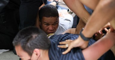Two men are detained by plainclothes officers with Immigration and Customs Enforcement (ICE) in the hallway outside of a courtroom following their court hearing at New York-Federal Plaza Immigration Court inside the Jacob K. Javitz Federal Building in New York City, U.S., June 6, 2025. (AFP Photo)