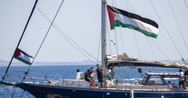Activist Greta Thunberg and crew stand aboard the aid ship Madleen, which will travel to Gaza to deliver humanitarian aid before setting sail from the port of Catania, Italy, June 1, 2025. (AA Photo)