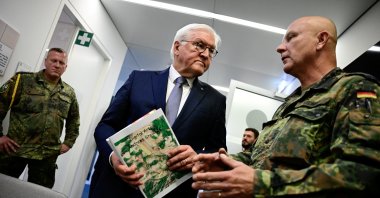 German President Frank-Walter Steinmeier listens to Sergeant Major, medical officer and artist Andreas Steinkat who explains his art pieces hanging in the Veterans Office, in Berlin, Germany, June 3, 2025. (Reuters Photo)