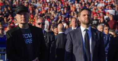 Elon Musk (L) and Republican vice presidential nominee Sen. JD Vance, R-Ohio, listen as Republican presidential nominee former President Donald Trump speaks at a campaign rally, Butler, U.S., Oct. 5, 2024. (AP Photo)