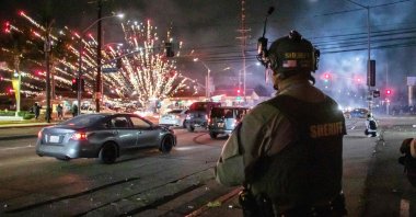 A firework sent by protesters explodes near the Los Angeles Sheriff Department officers during immigration protests, Paramount, California, U.S., June 7, 2025. (AFP Photo)