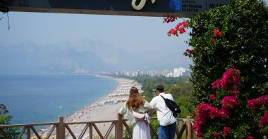 Tourists are photographed while enjoying a view of a beach in Antalya, southern Türkiye, June 6, 2025. (IHA Photo)