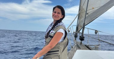 Turkish activist Yasemin Acar poses for a photo onboard the Madleen wave at the camera near Sicily, Italy, June 6, 2025. (AA Photo)