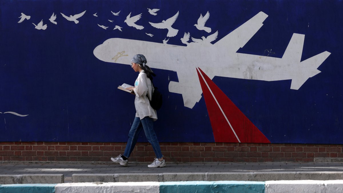 A woman walks in front of an anti-U.S. mural next to the former U.S. embassy in Tehran, Iran, June 5, 2025. (EPA Photo)
