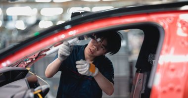 A laborer works on an assembly line during the organized press tour in the AVATR EV factory, Chongqing, China, May 20, 2025. (EPA Photo)