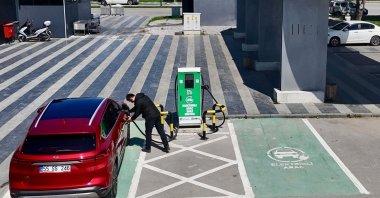 A person charges an electric Togg T10X at a fast charging station set up in northern Samsun province, Türkiye, May 20, 2025. (IHA Photo)