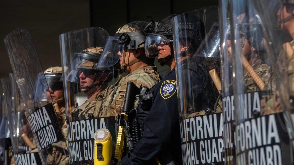 California National Guard members stand outside the Federal Building as people gather to protest in response to federal immigration operations, Los Angeles, U.S., June 9, 2025. (AFP Photo)