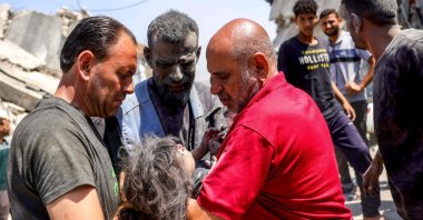People hold an injured Palestinian child pulled from the rubble of the Shaheen family home, which was targeted in an Israeli strike in the Saftawi neighbourhood, west of Jabalia, Gaza Strip, Palestine, June 9, 2025. (AFP Photo)