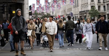 People carry shopping bags as they walk along Regent Street, London, Britain, May 15, 2025. (EPA Photo)