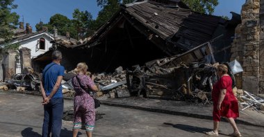 Local residents stand next to a destroyed building following a drone attack, Odesa, Ukraine, June 10, 2025. (AFP Photo)