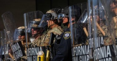 California National Guard members stand outside the Federal Building as people gather to protest in response to federal immigration operations, Los Angeles, U.S., June 9, 2025. (AFP Photo)