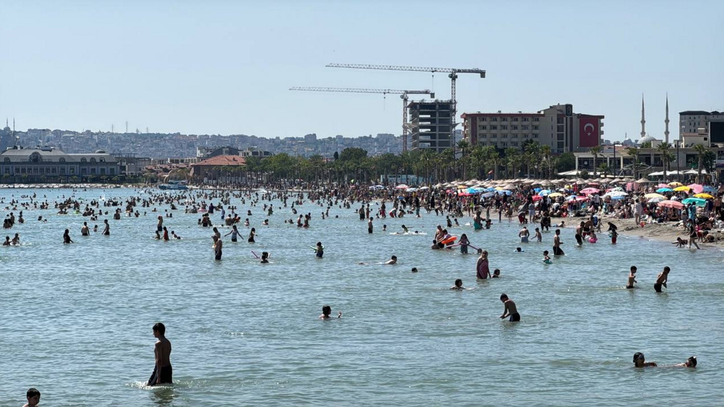 People enjoy the warm weather on the fourth day of Eid al-Adha, gathering along the beach, Istanbul, Türkiye, June 9, 2025. (AA Photo)