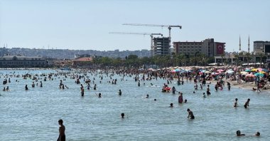People enjoy the warm weather on the fourth day of Eid al-Adha, gathering along the beach, Istanbul, Türkiye, June 9, 2025. (AA Photo)