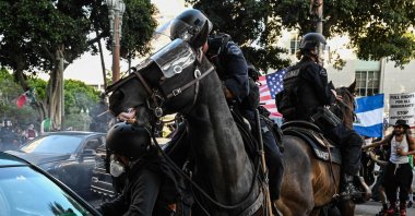 LAPD officers on horseback clash with protesters gathered near Los Angeles City Hall to protest against federal immigration operations, Los Angeles, U.S., June 11, 2025. (AFP Photo)