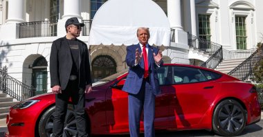 U.S. President Donald Trump talks to the media next to Tesla CEO Elon Musk, with a Tesla car in the background, at the White House, Washington, D.C., U.S., March 11, 2025. (Reuters Photo)