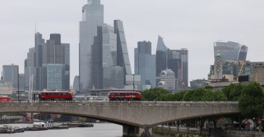 Buses cross Waterloo Bridge, backdropped by skyscrapers in the City of London financial district, London, U.K., May 15, 2025. (Reuters Photo)