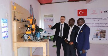 Officials inspect carpentry workshop machines provided by the Turkish Cooperation and Coordination Agency (TIKA) at a school for orphans, Alux, Uganda, June 12, 2025. (AA Photo)