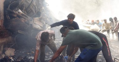 Rescue officials work at the site where Air India flight 171 crashed in a residential area near the airport, Ahmedabad, India, June 12, 2025. (AFP Photo)