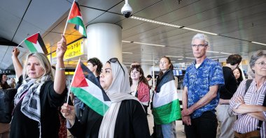 People wave Palestinian flags as participants in the &#039;Global March to Gaza&#039; depart from Schiphol Airport for Egypt at Schiphol, The Netherlands, June 11, 2025. (EPA Photo)