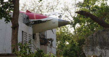 The tail of the airplane is seen stuck in a building at the site of an airplane that crashed in India&amp;amp;#039;s northwestern city of Ahmedabad in Gujarat state, June 12, 2025. (AP Photo)