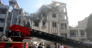 Rescue teams work outside a heavily damaged building, targeted by an Israeli strike, Tehran, Israel, June 13, 2025. (AFP Photo)