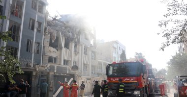 Firefighters, rescue workers and security personnel work around a building that was hit by Israeli airstrikes, Tehran, Iran, June 13, 2025. (EPA Photo)