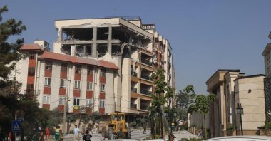 Onlookers gather in front of a building targeted by an Israeli strike, Tehran, Iran, June 13, 2025. (AFP Photo)