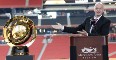 FIFA President Gianni Infantino gestures toward the FIFA Club World Cup trophy during a news conference at Mercedes-Benz Stadium, Atlanta, U.S., April 14, 2025. (AP Photo)