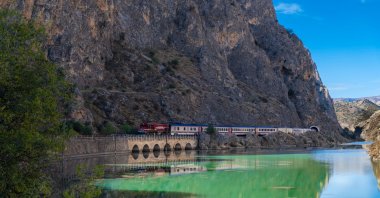 The Touristic Karaelmas Express runs close to mountains and water, showcasing Türkiye’s natural beauty, June 12, 2025. (DHA Photo)